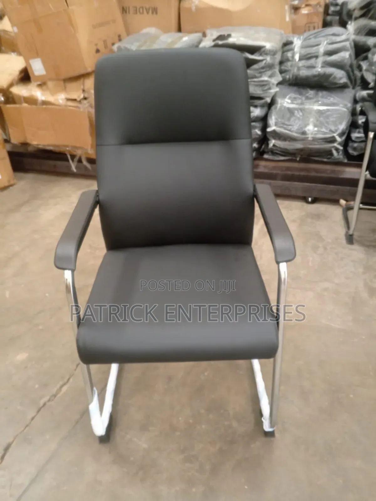 This Black Leather Cantilever Visitor Chair With Fixed Padded Arms