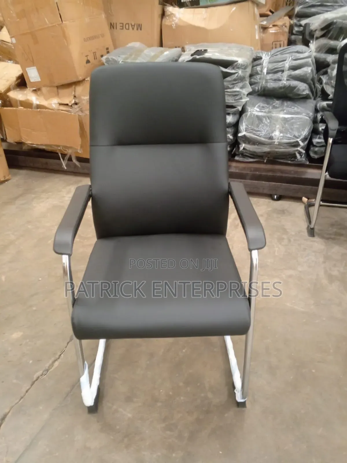 This Black Leather Cantilever Visitor Chair With Fixed Padded Arms