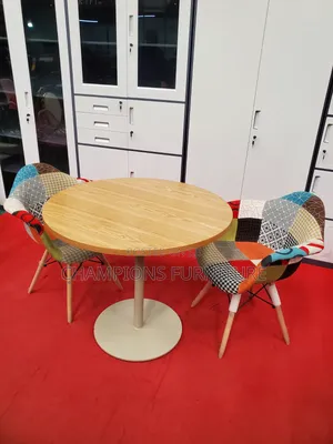 Brown Round Table and Patchwork Eames Chairs Set