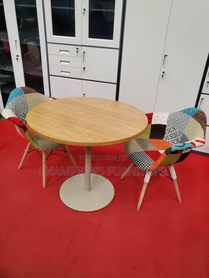 Brown Round Table and Patchwork Eames Chairs Set