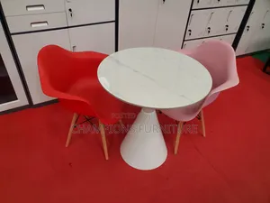 Round Trumpet Base Table and Eames Armchairs