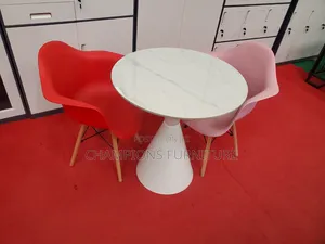 Round Trumpet Base Table and Eames Armchairs