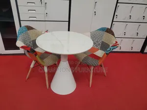 Round Trumpet Base Table and Patchwork Eames ArmChairs