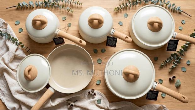 Aesthetic Ceramic Cookware Set With Wood-Grain Handles and Knobs.