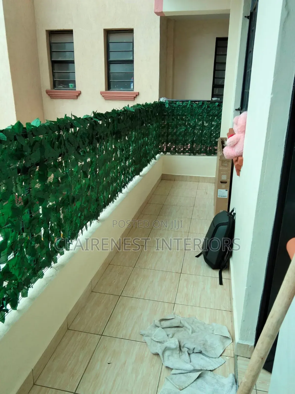Create a Lush Balcony Enclosure With Green Artificial Fence