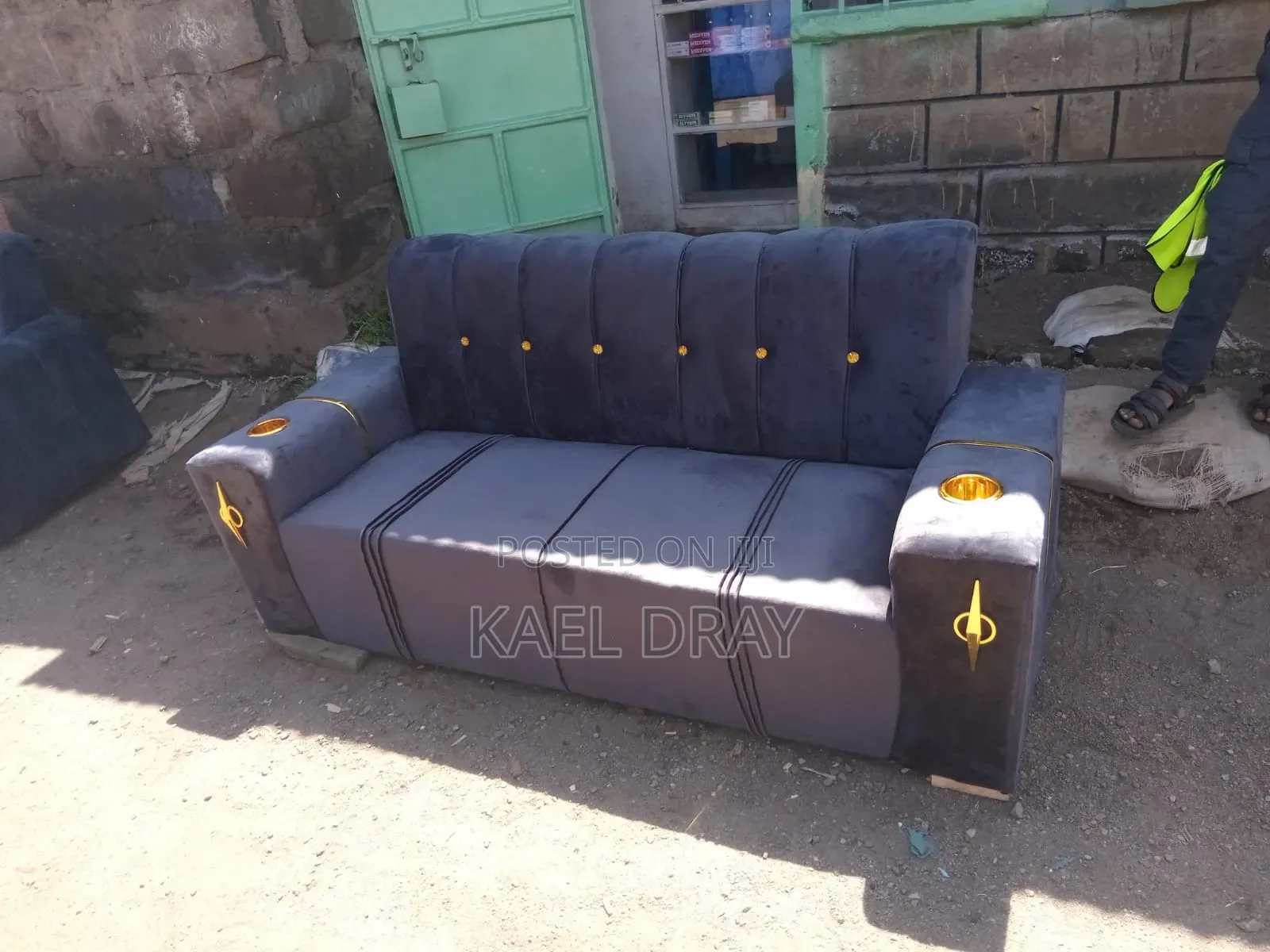 Navy Channel-Tufted Sofa With Gold Cup Holders Trim