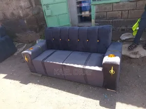Navy Channel-Tufted Sofa With Gold Cup Holders Trim