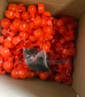 Red Plastic Automatic Poultry Drinking Cups Fitted Onto a Bucket