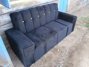 Black Channel-Tufted Sofa With Gold Button Detailing