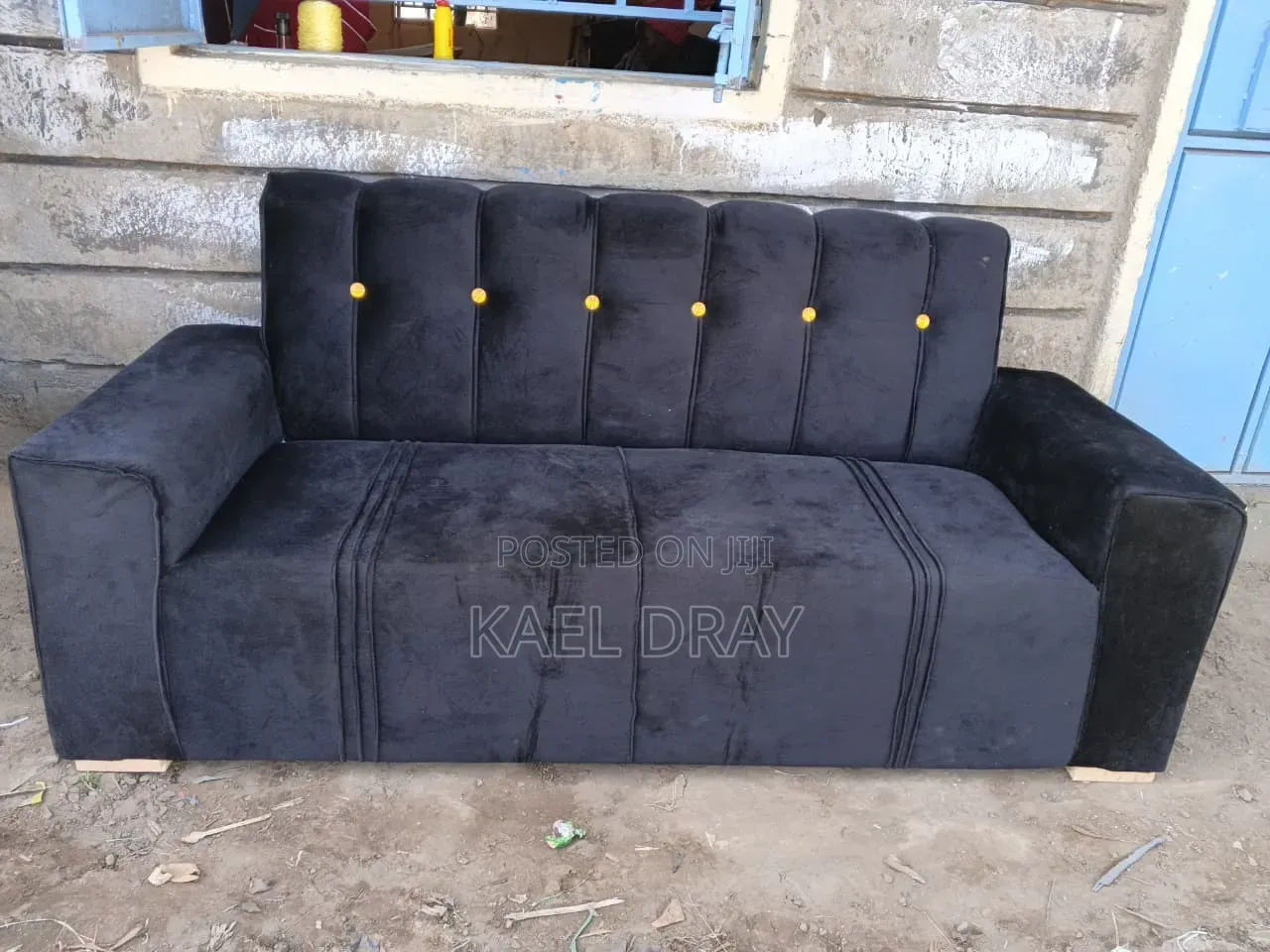 Black Channel-Tufted Sofa With Gold Button Detailing