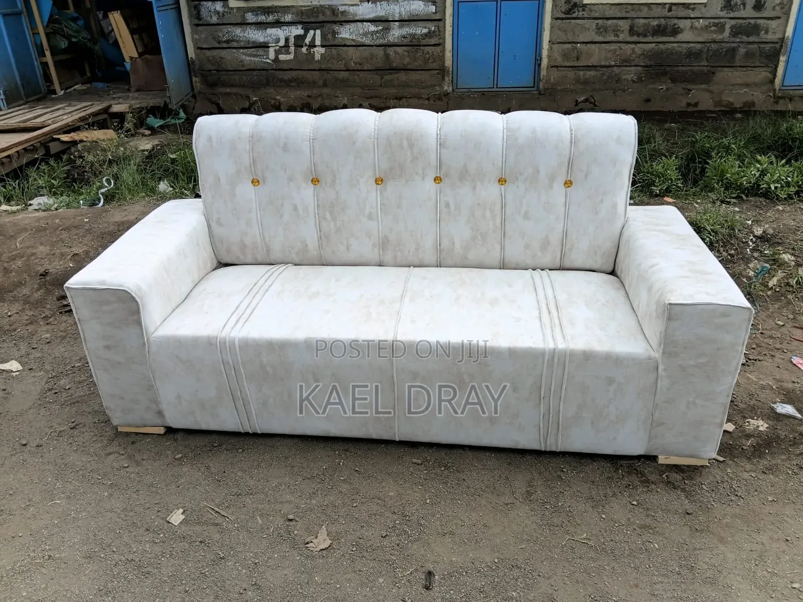 Cream Channel-Tufted Sofa With Gold Button Detailing