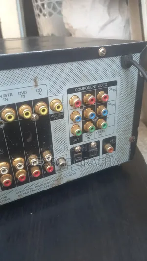 LG Receiver With Its Powered Subwoofer and One Tallboy Speaker