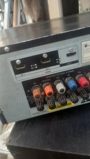 LG Receiver With Its Powered Subwoofer and One Tallboy Speaker