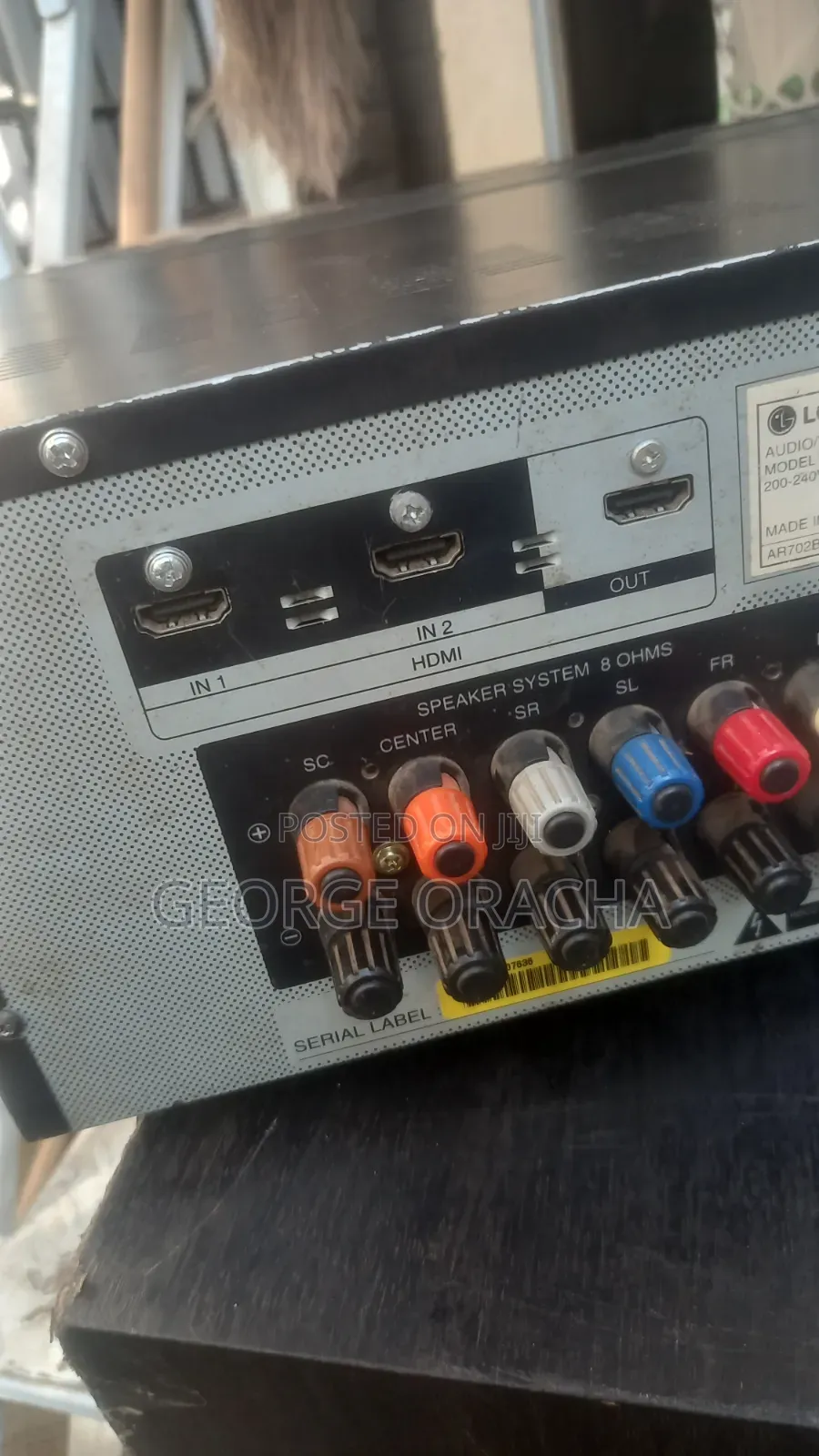 LG Receiver With Its Powered Subwoofer and One Tallboy Speaker