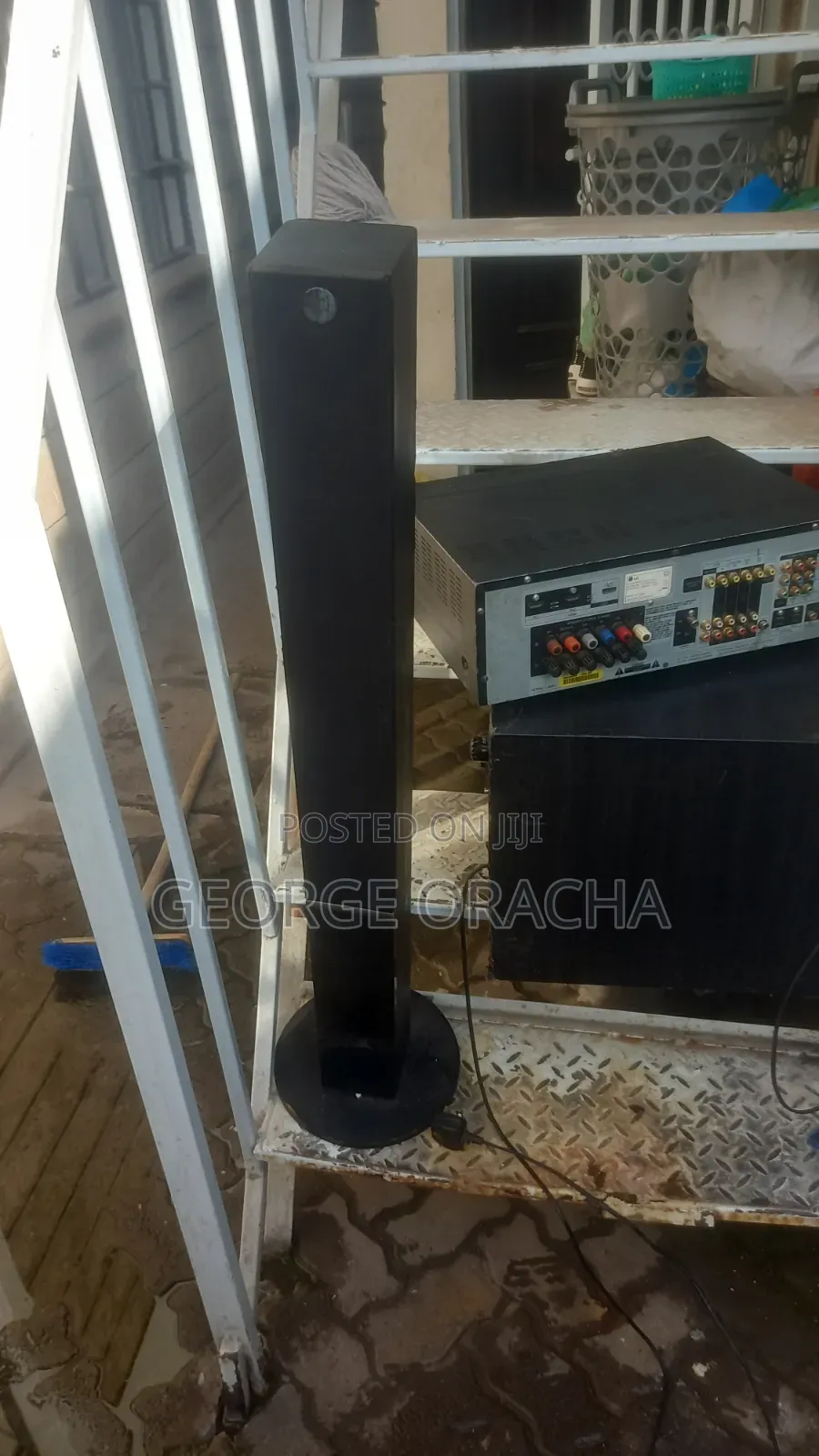 LG Receiver With Its Powered Subwoofer and One Tallboy Speaker
