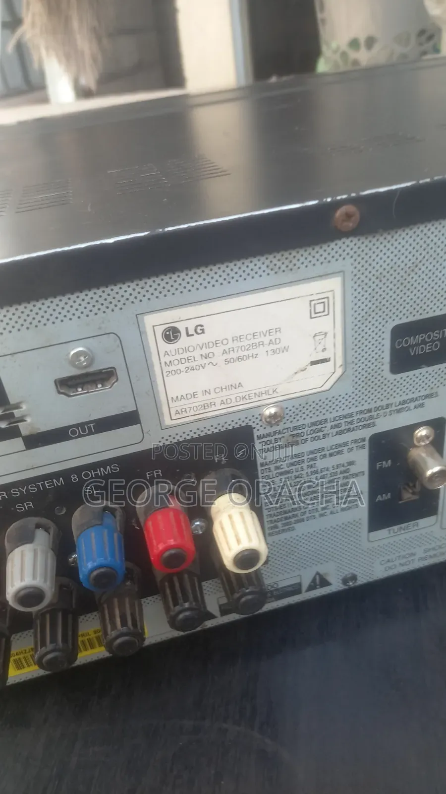 LG Receiver With Its Powered Subwoofer and One Tallboy Speaker