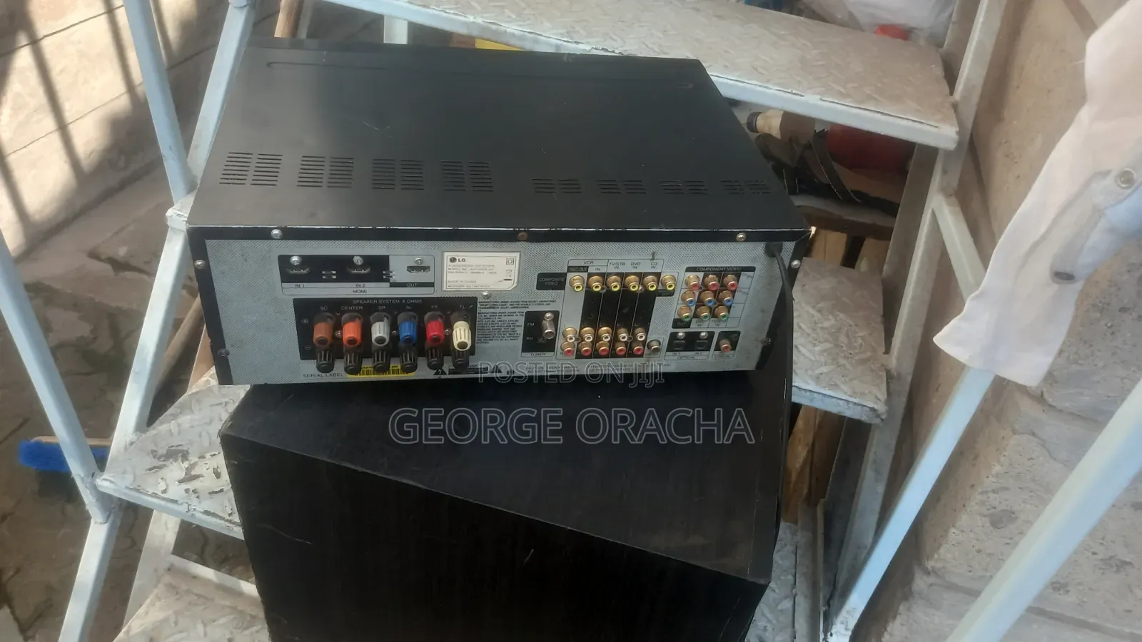 LG Receiver With Its Powered Subwoofer and One Tallboy Speaker