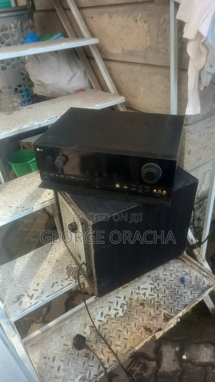 LG Receiver With Its Powered Subwoofer and One Tallboy Speaker
