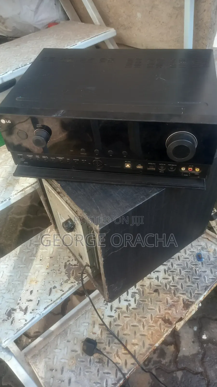 LG Receiver With Its Powered Subwoofer and One Tallboy Speaker