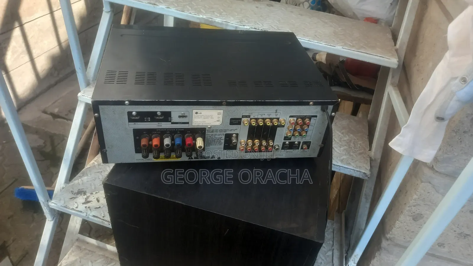 LG Receiver With Its Powered Subwoofer and One Tallboy Speaker