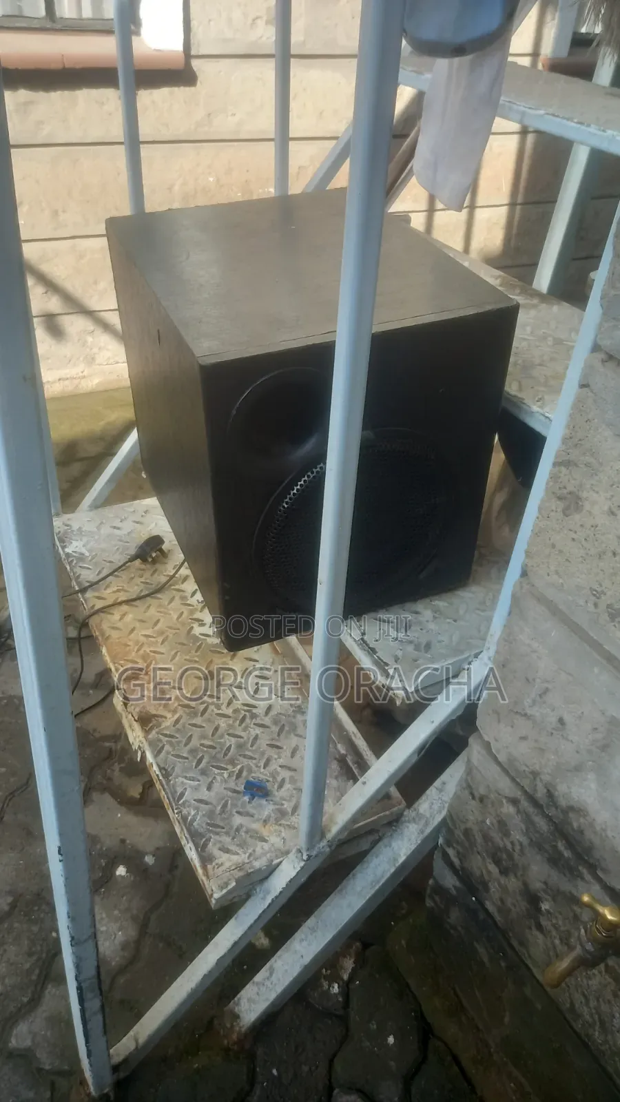 LG Receiver With Its Powered Subwoofer and One Tallboy Speaker