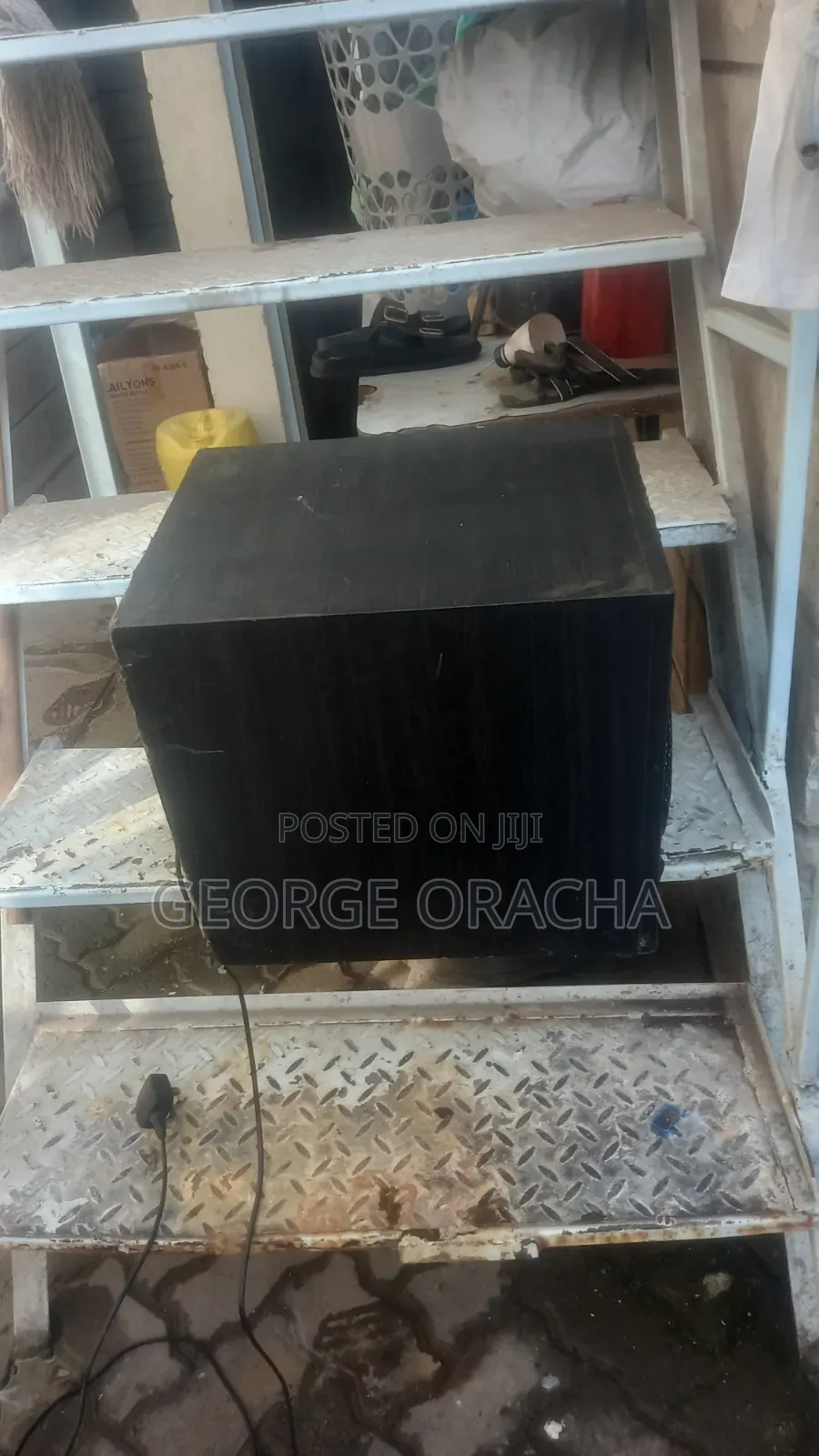 LG Receiver With Its Powered Subwoofer and One Tallboy Speaker