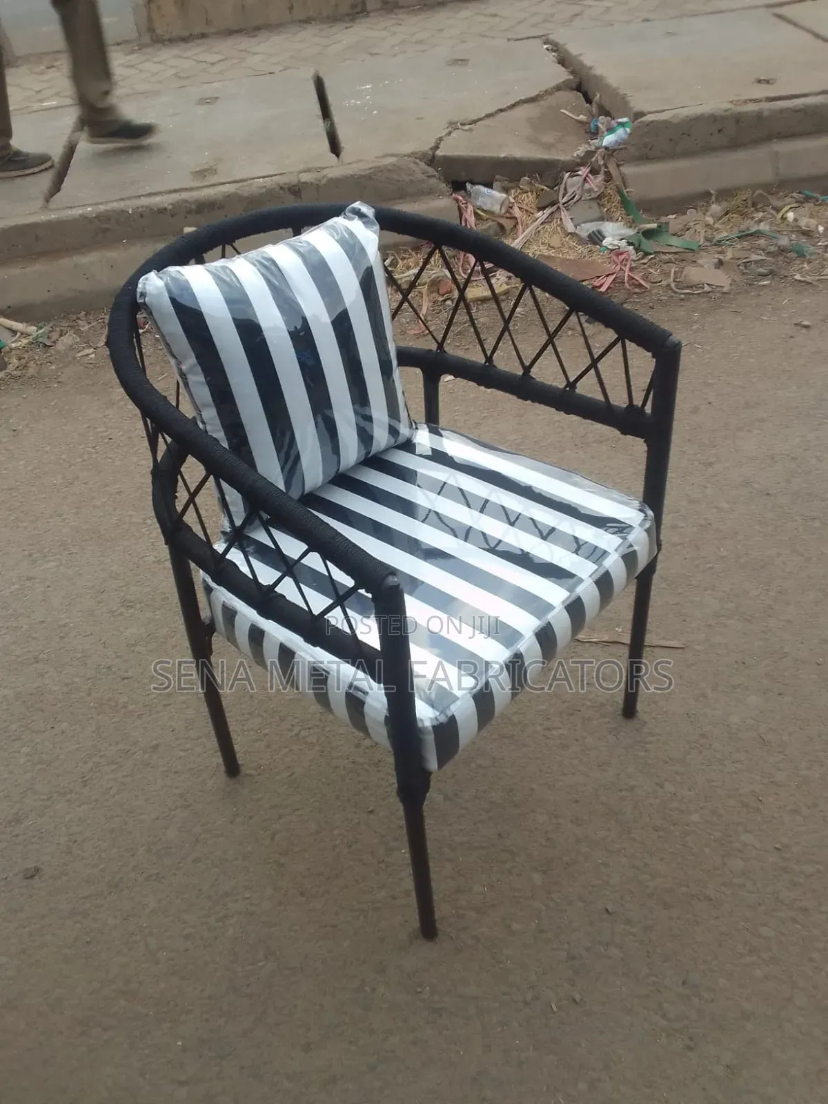 Black and White Outdoor Woven Chair With Polythene Protective Finish.