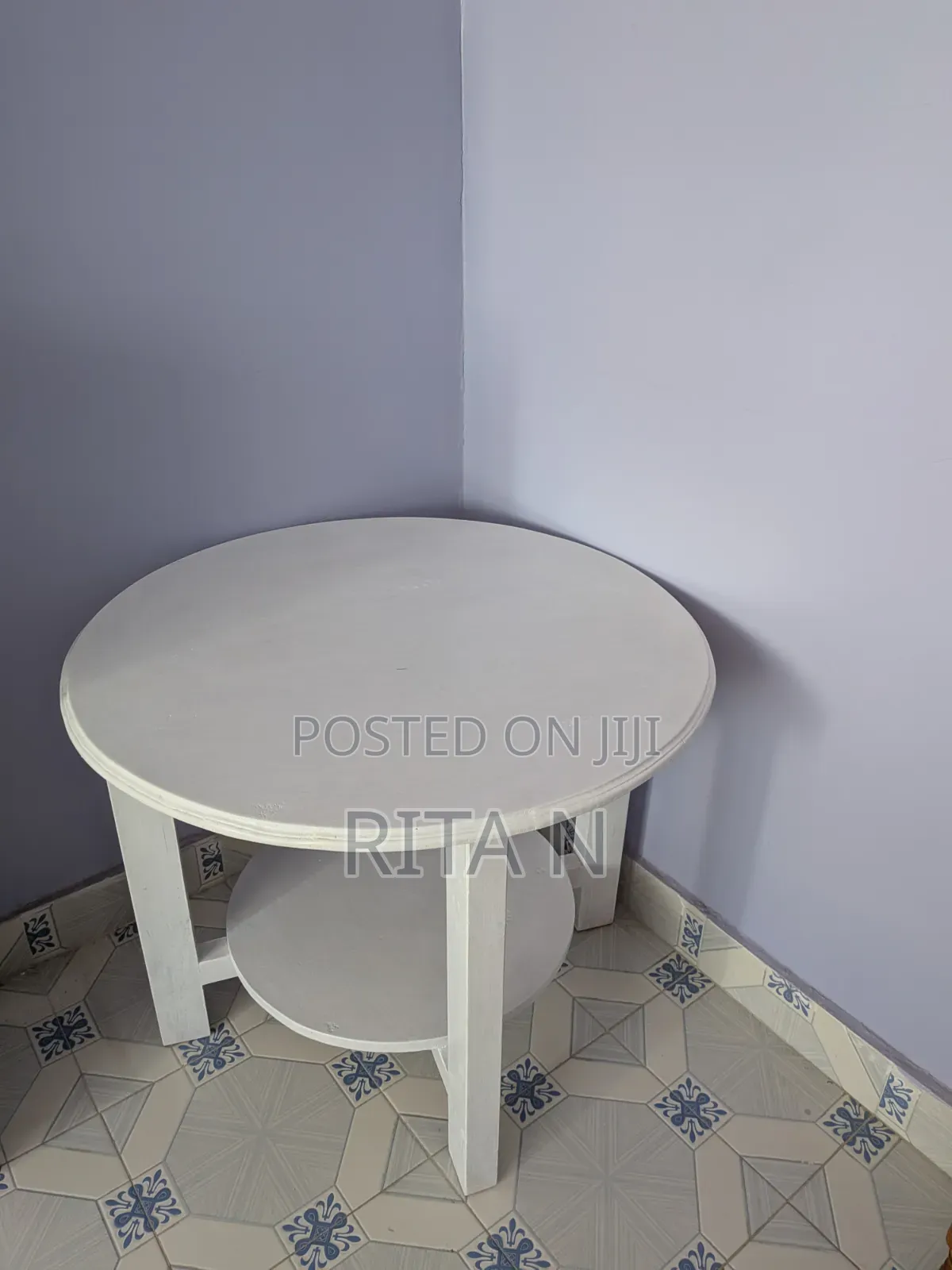 A Small White Wooden Table Perfect for a Living Room Setting