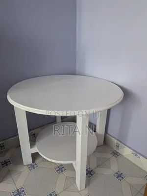 A Small White Wooden Table Perfect for a Living Room Setting