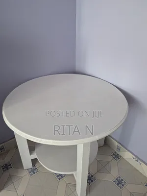 A Small White Wooden Table Perfect for a Living Room Setting