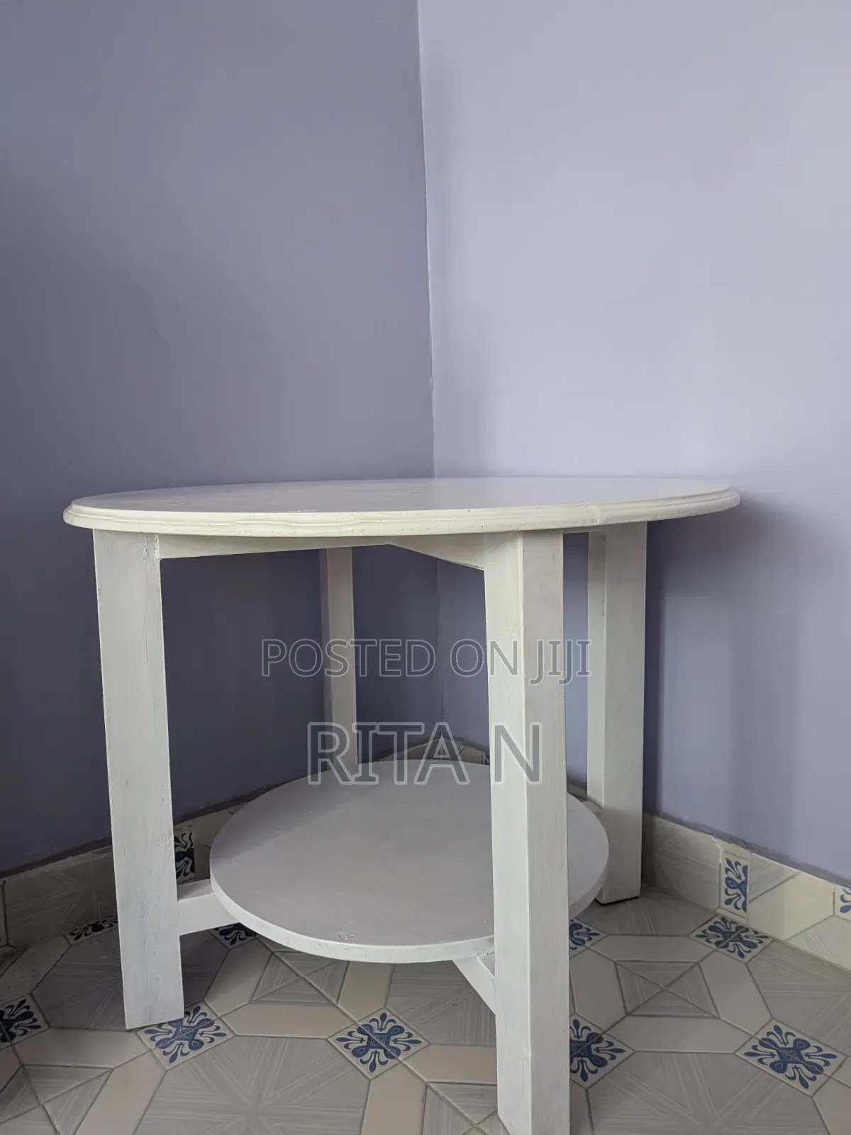 A Small White Wooden Table Perfect for a Living Room Setting