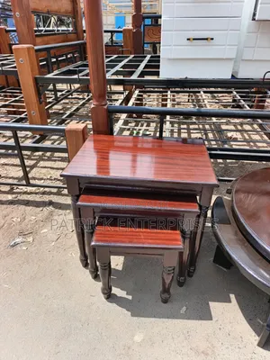 This Image Displays a Classic Mahogany-Finish Wooden Nesting Table Set