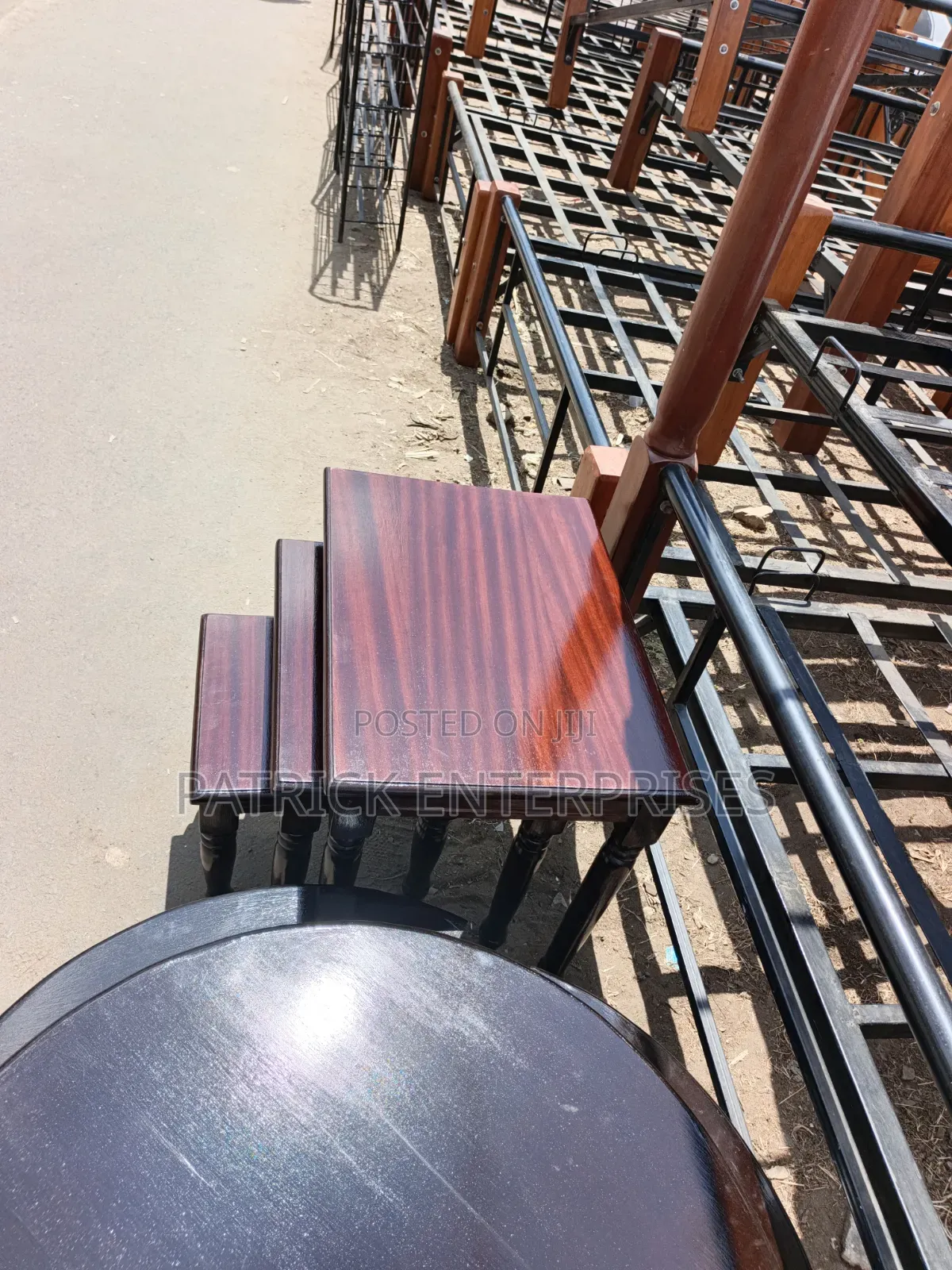 This Image Displays a Classic Mahogany-Finish Wooden Nesting Table Set