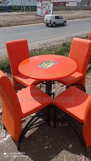 A Set of Executive Orange Color Seats and a Table