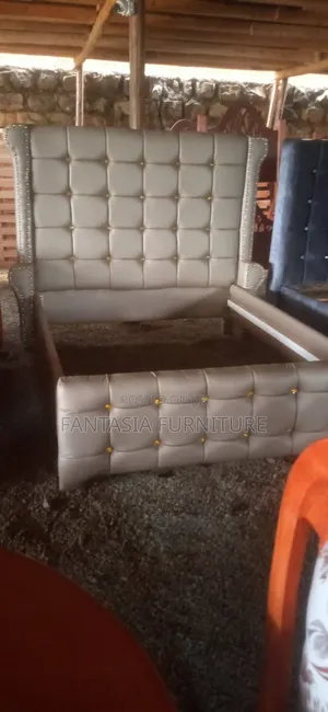 Beige Tufted 5 by 6 Bed.