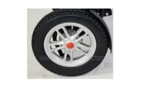 Rear Wheel Assembly With a Black Tire and Silver Rim for a Wheelchair