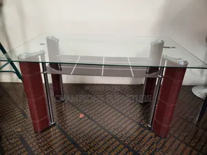 Sleek Glass Top Dining Table With Bottom Shelf