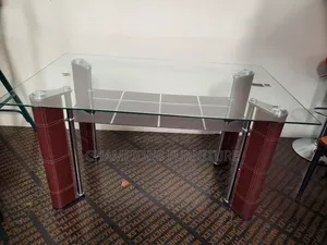 Sleek Glass Top Dining Table With Bottom Shelf