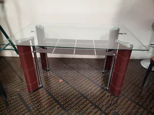 Sleek Glass Top Dining Table With Bottom Shelf