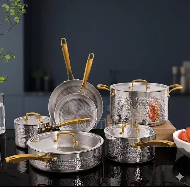 Tri-Ply Hammered Stainless Steel Cookware Set With Gold Handles.