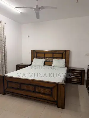 A King Size Bed With Two Matching Nightstands.