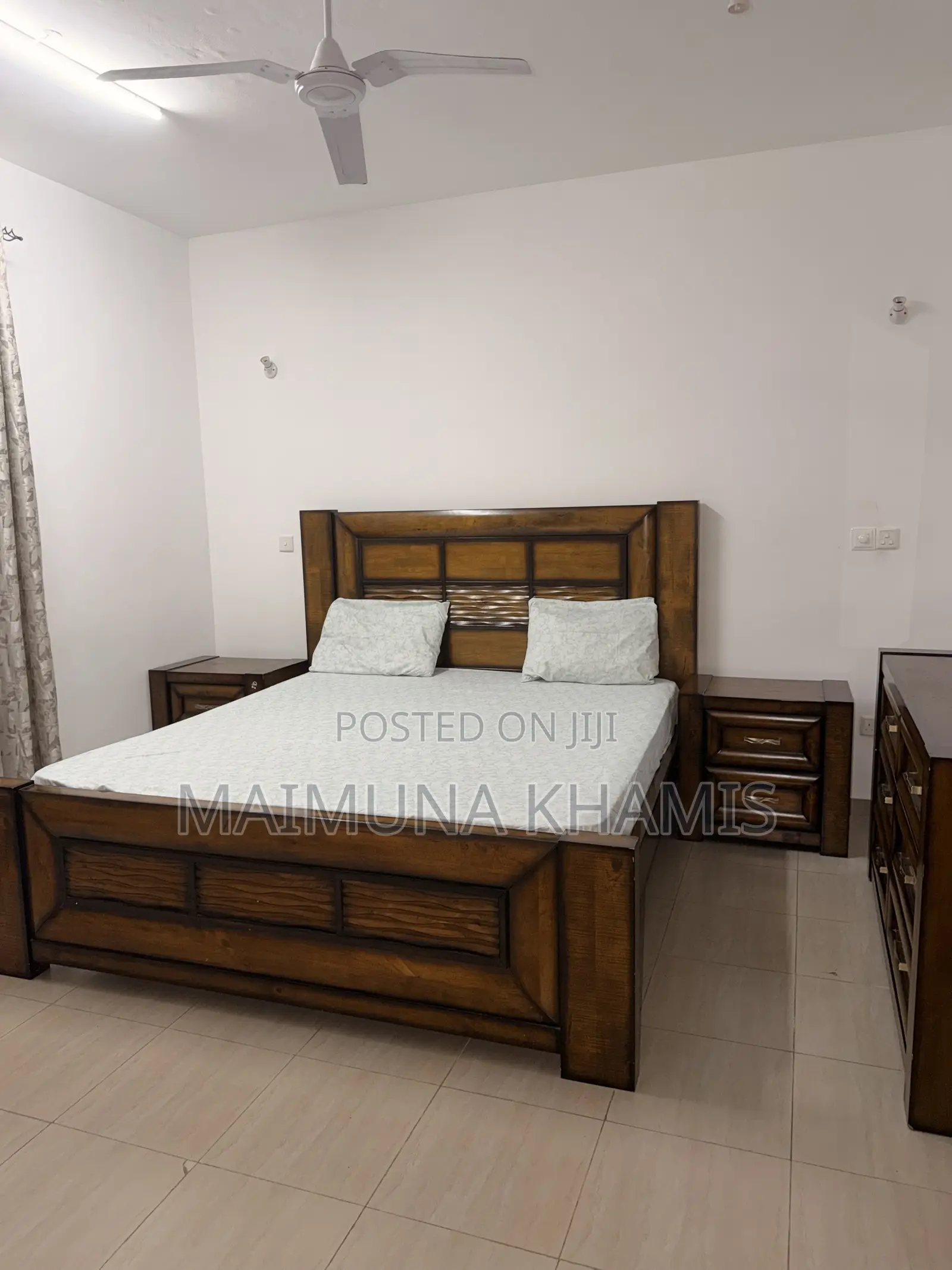 A King Size Bed With Two Matching Nightstands.