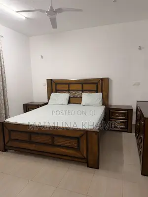 A King Size Bed With Two Matching Nightstands.