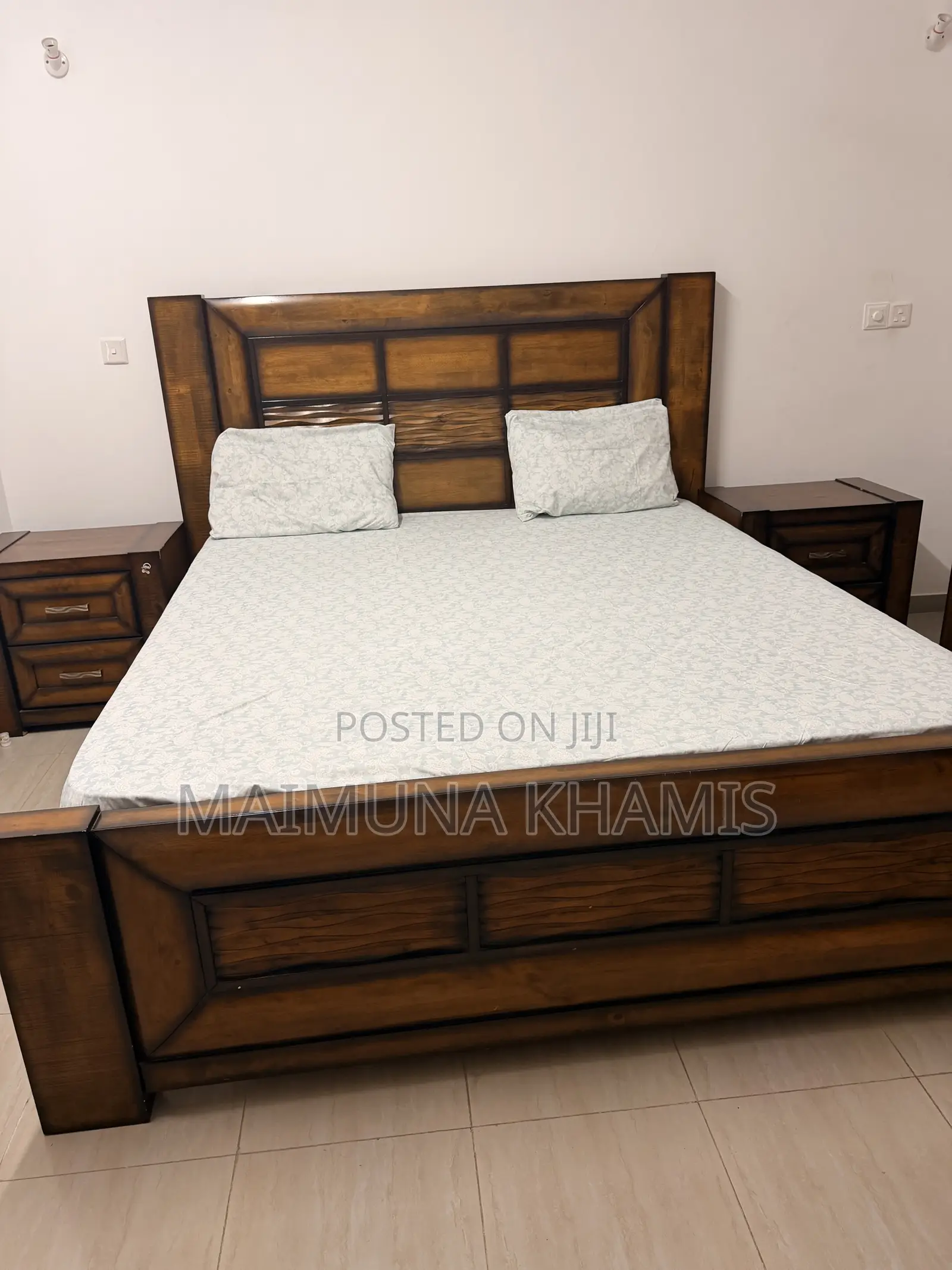A King Size Bed With Two Matching Nightstands.