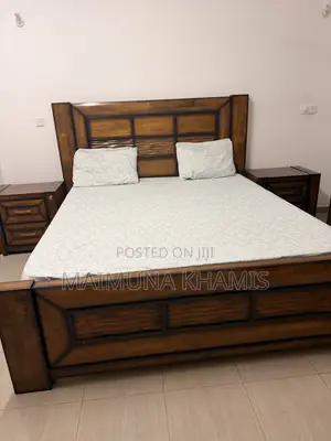 A King Size Bed With Two Matching Nightstands.