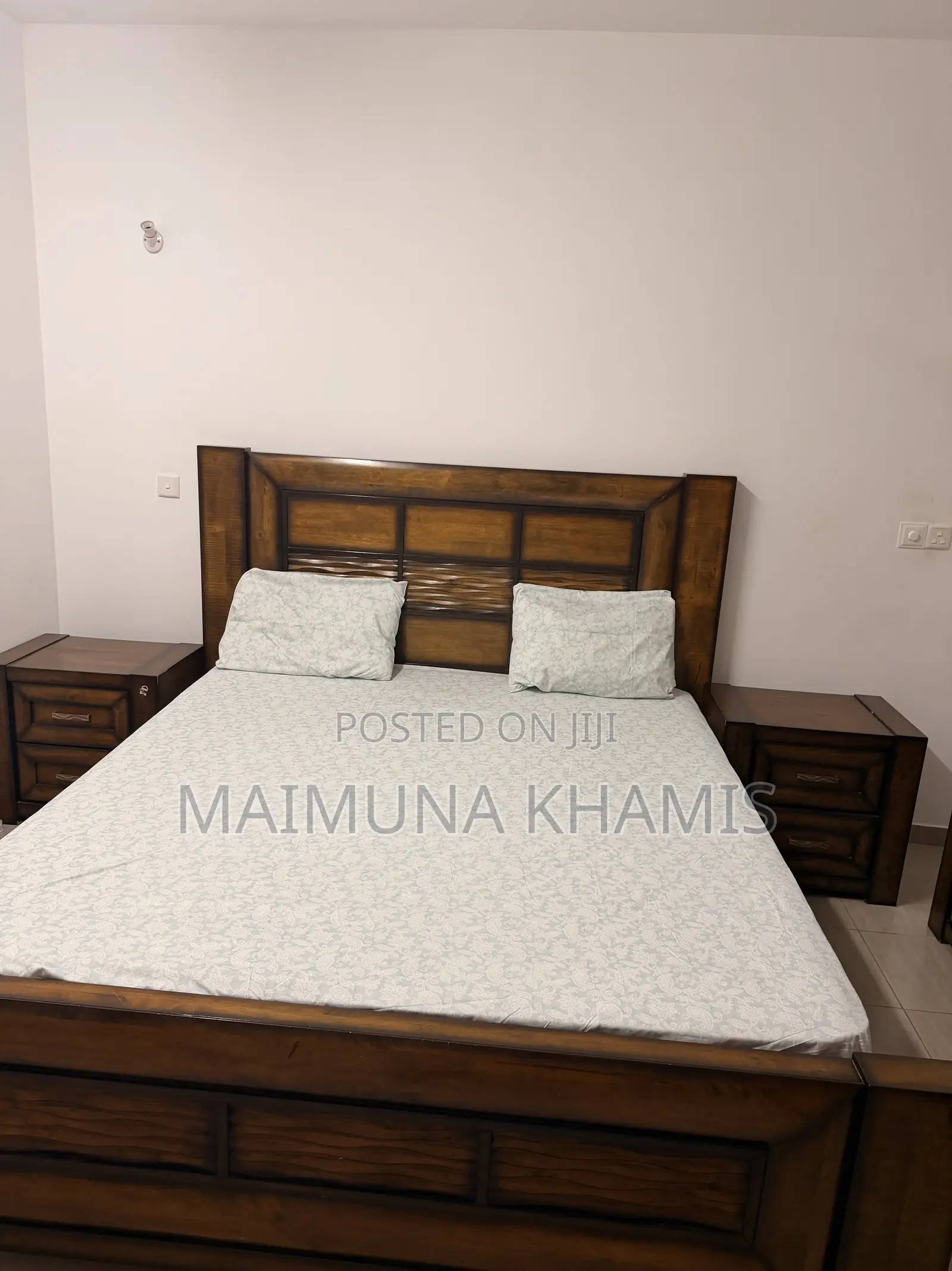 A King Size Bed With Two Matching Nightstands.