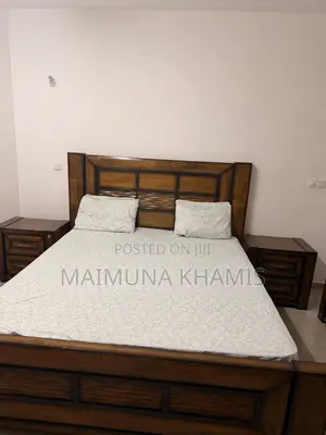 A King Size Bed With Two Matching Nightstands.