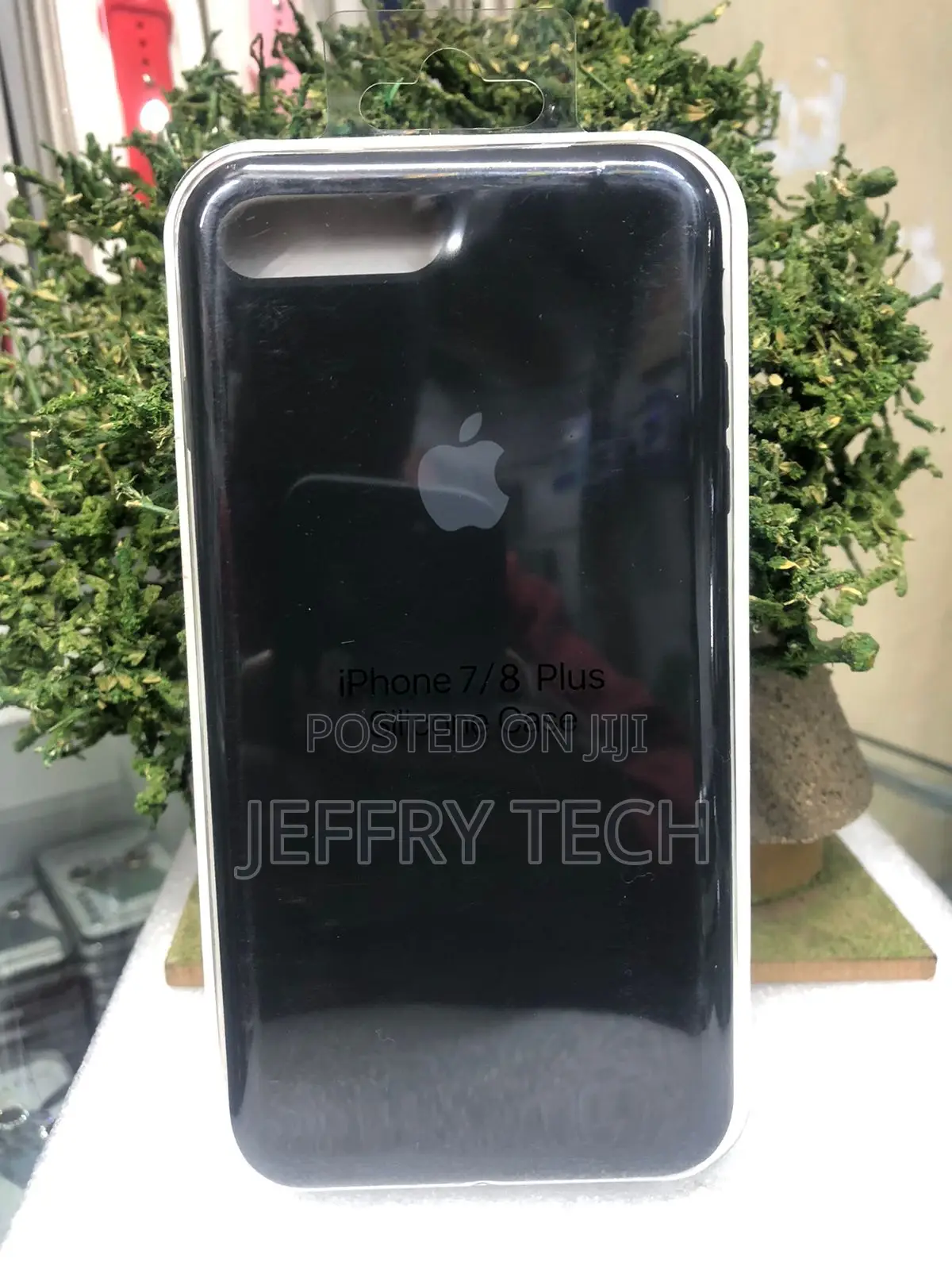 Black Marble-Patterned Phone Case With a Phone Grip for an iPhone 8.