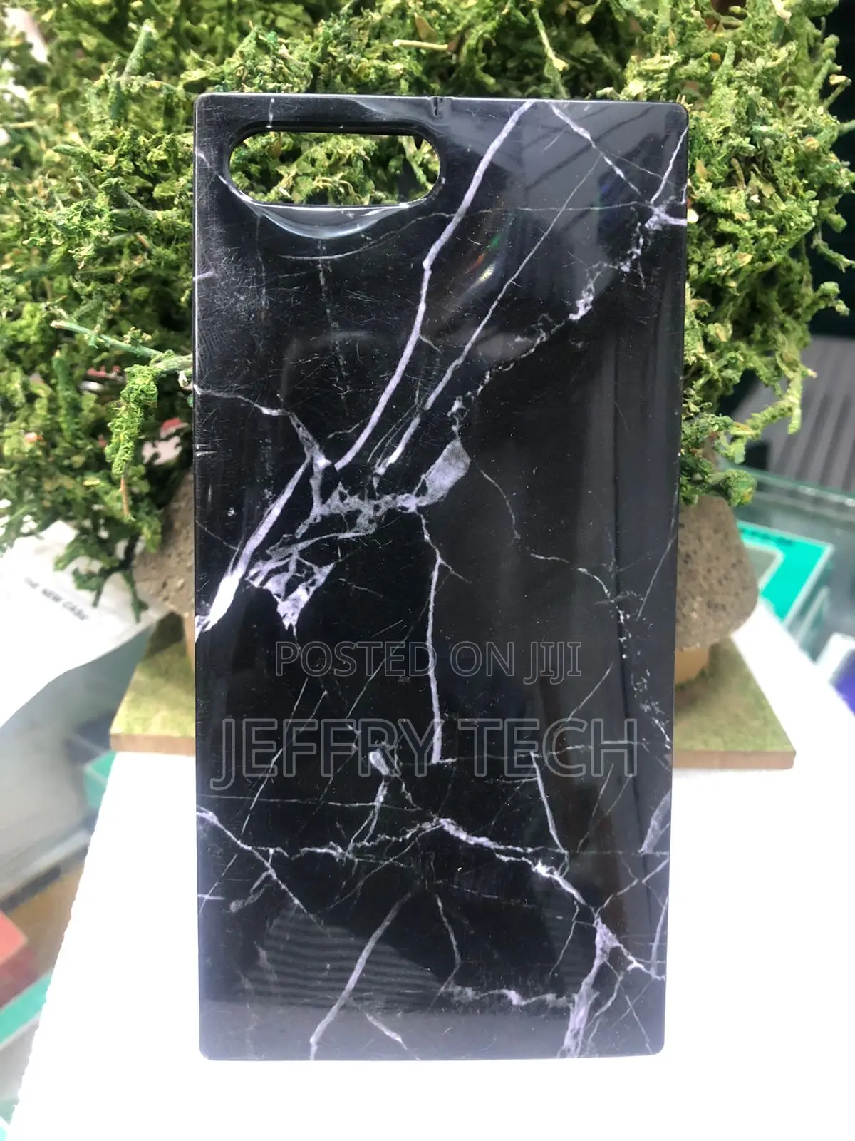 Square-Edged Smartphone Case Featuring a Black Marble iPhone 15 Pro