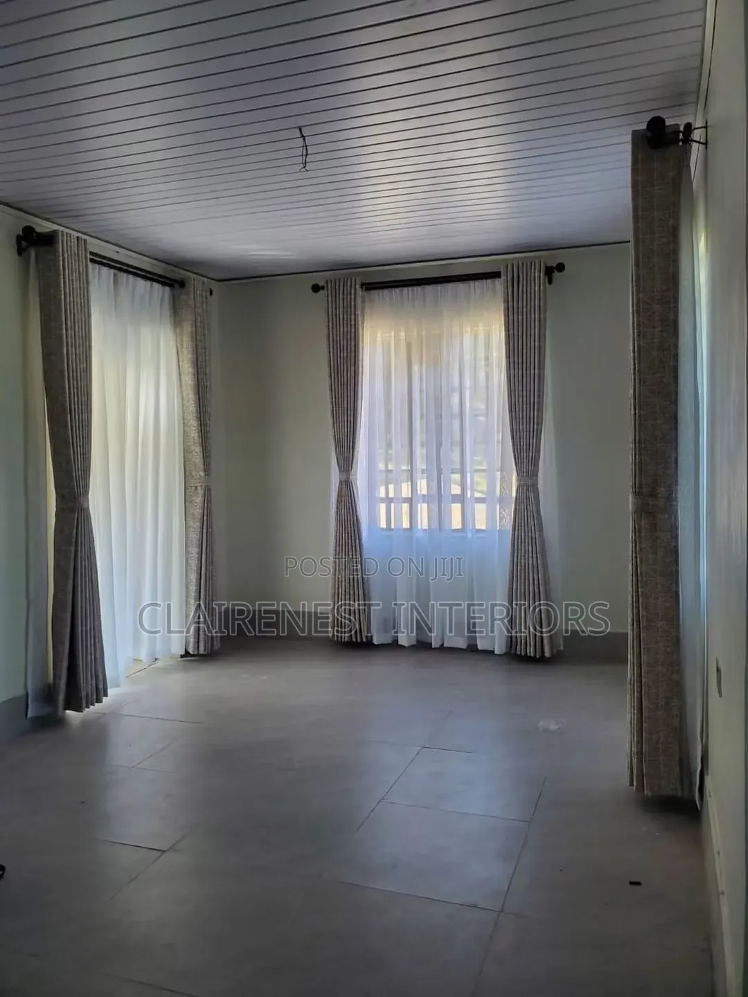 Dress Tall Windows With Elegant Flowing Curtains Fabrics.